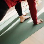 a person standing on a yoga mat on the floor