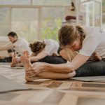 a group of people doing yoga in a room